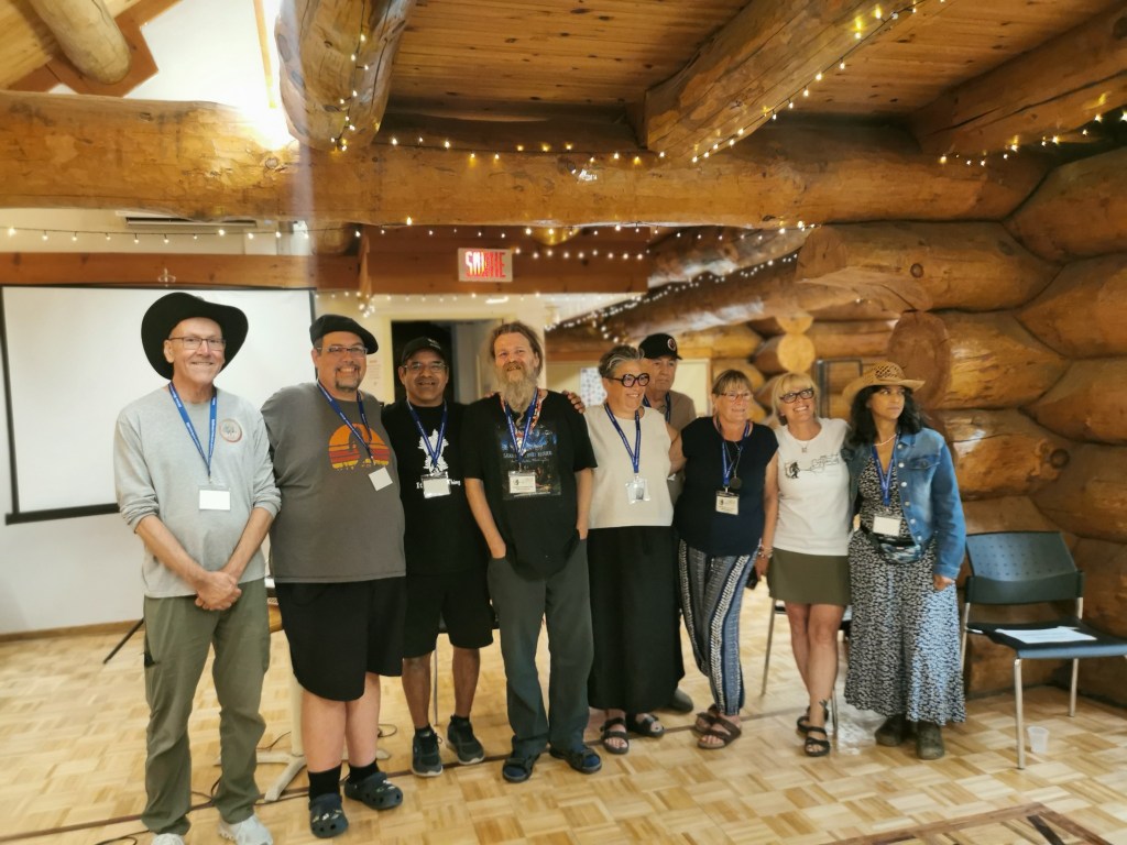 Group photo of participants at the first Sasquatch conference in Quebec, standing in a log cabin venue.